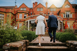 Bride and groom on steps in garden