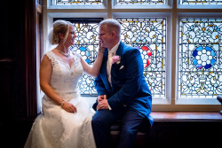 Bride and groom by window in great hall