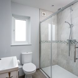 Modern bathroom with walk-in shower and chrome fixtures