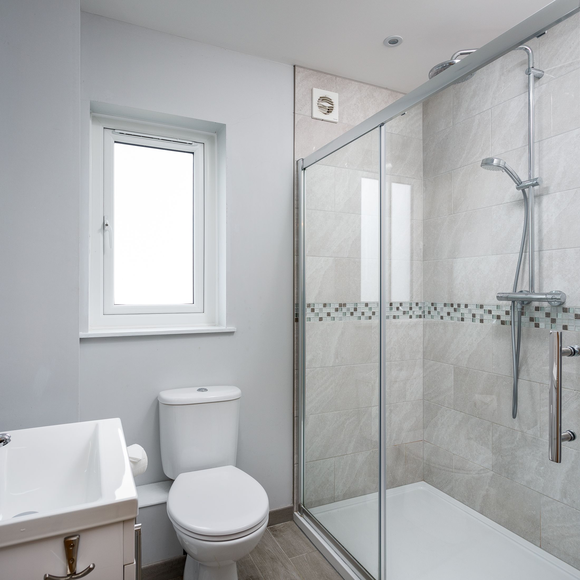 Modern bathroom with walk-in shower and chrome fixtures