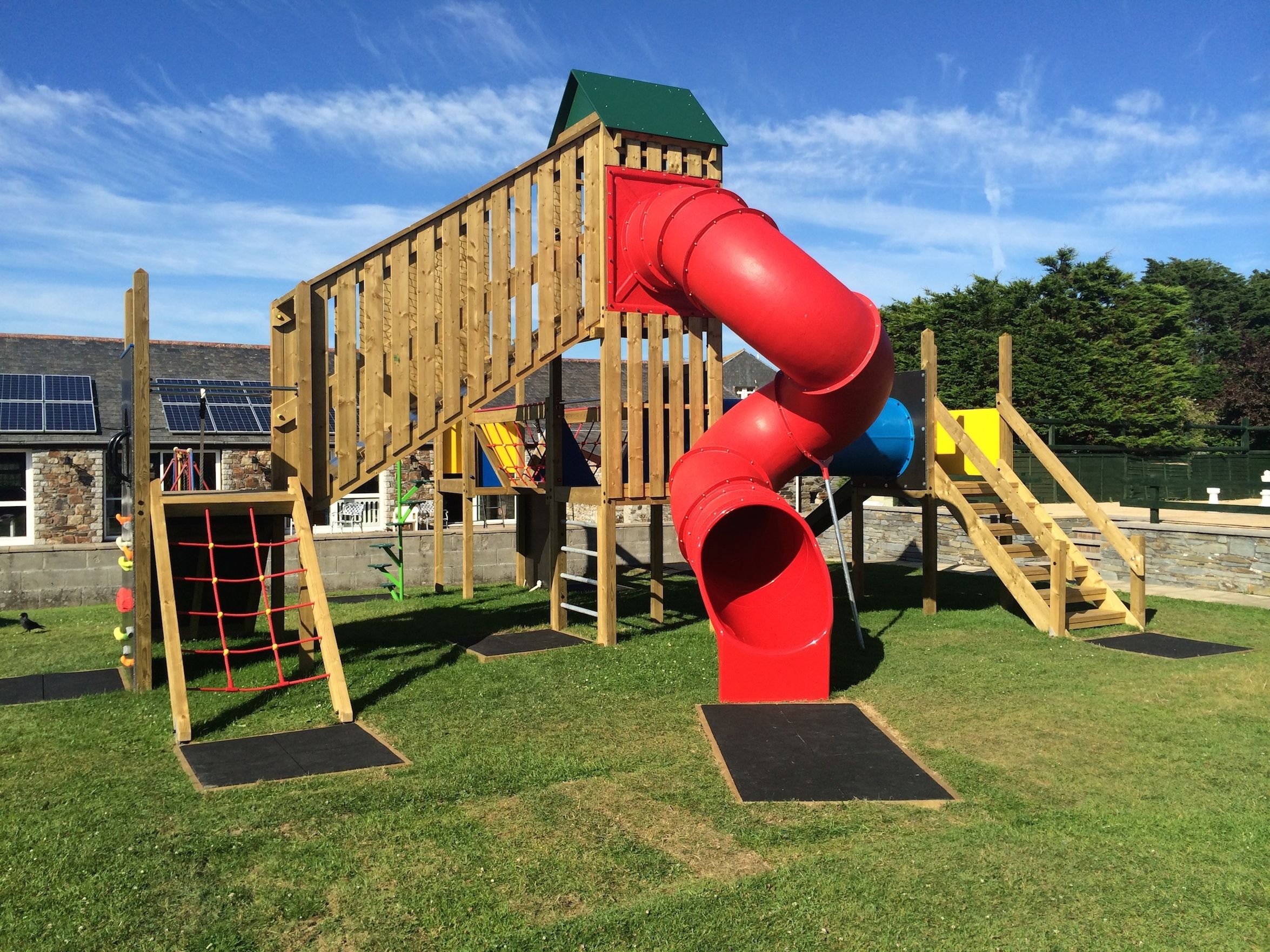 Children's outdoor playground with slide and climbing structure