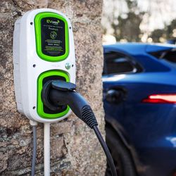 Electric car charging at a wall-mounted EV charger