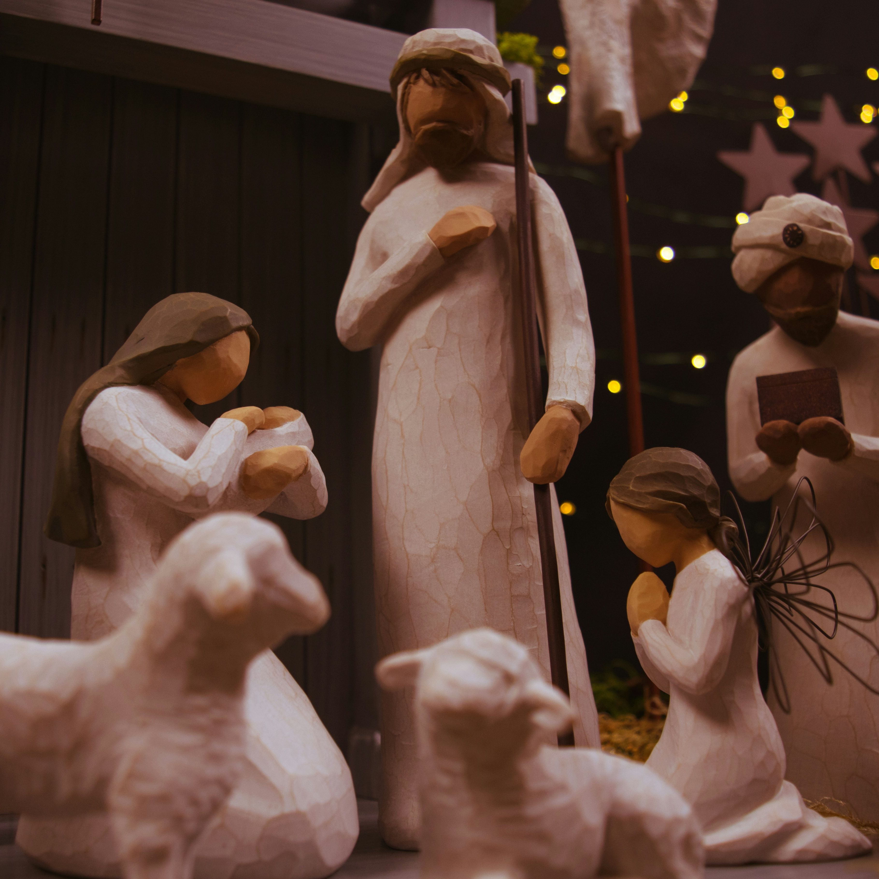 Wooden nativity scene with figures of Mary, Joseph, baby Jesus, wise men, an angel, and animals.