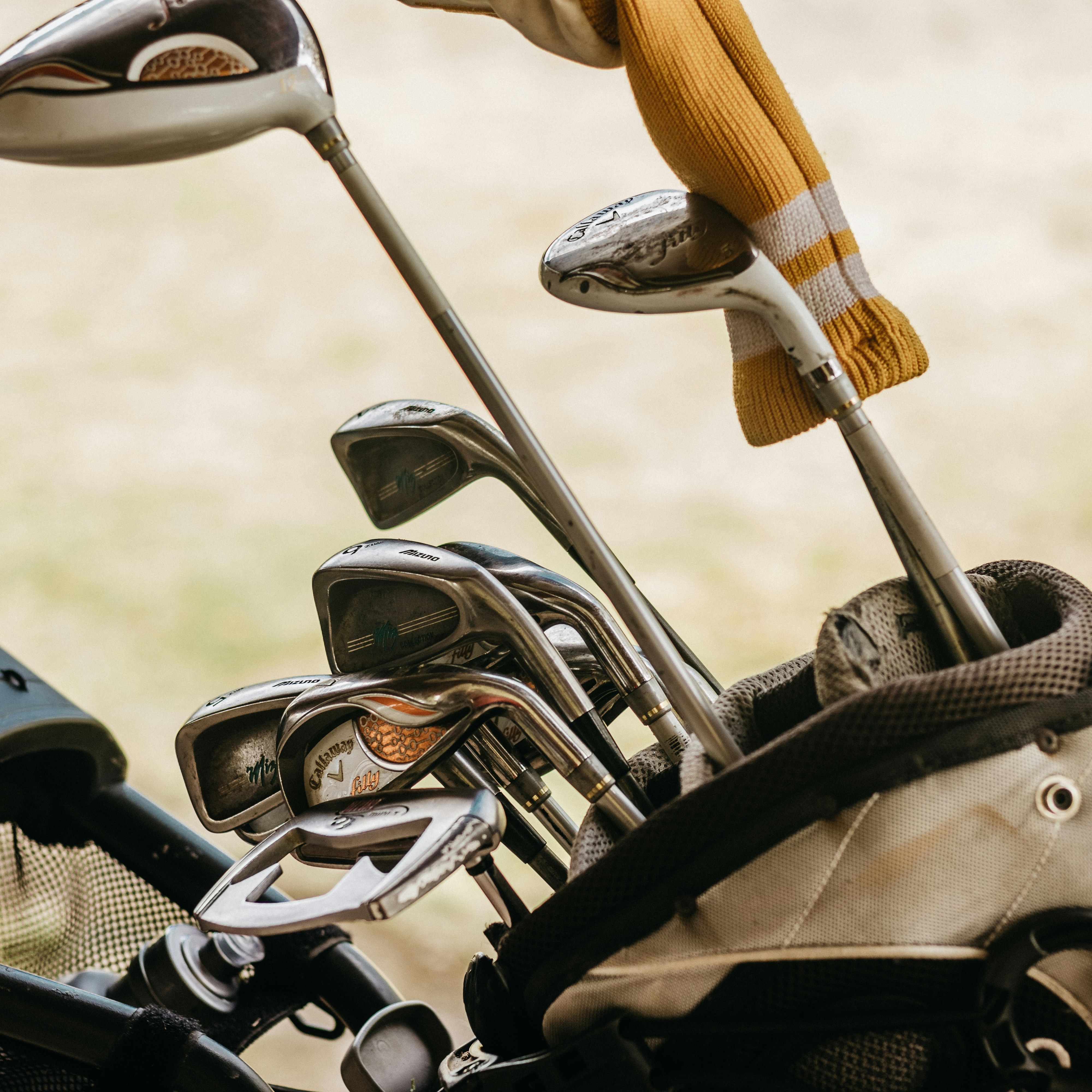 A close-up view of golf clubs in a golf bag.