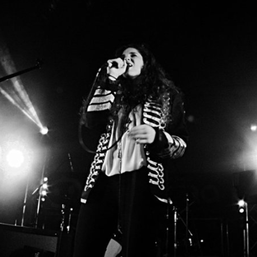 Singer performing on stage in black and white photo