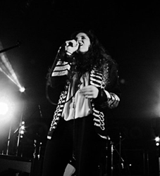 Singer performing on stage in black and white photo