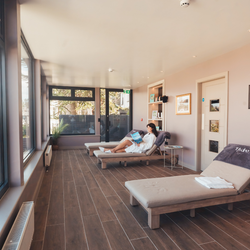 Woman relaxing on a lounge chair in a spa relaxation room