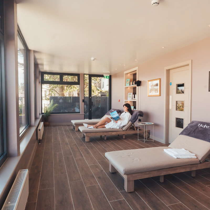 Woman relaxing on a lounge chair in a spa relaxation room