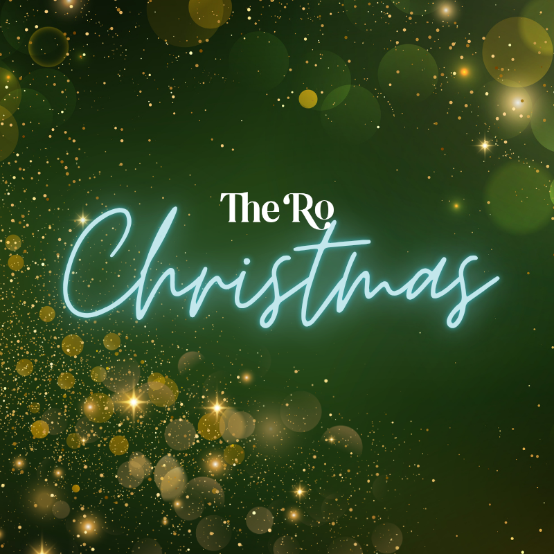 The Ro Christmas text on a green background with sparkling gold lights and bokeh effects