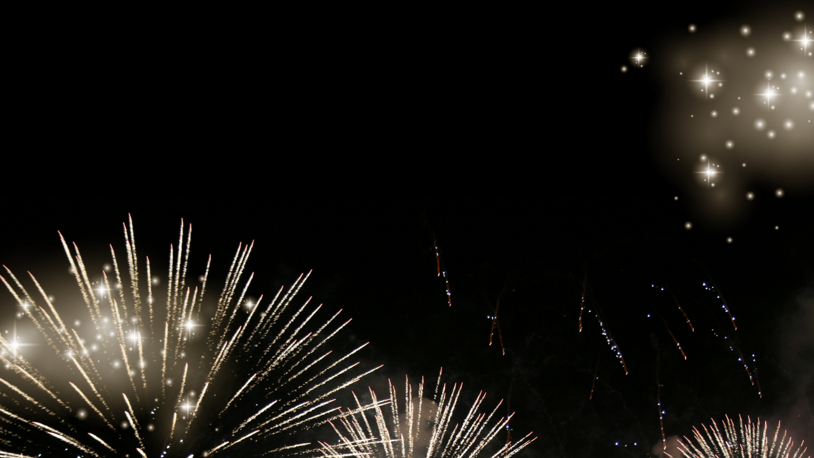 Fireworks exploding in the night sky with bright sparkles