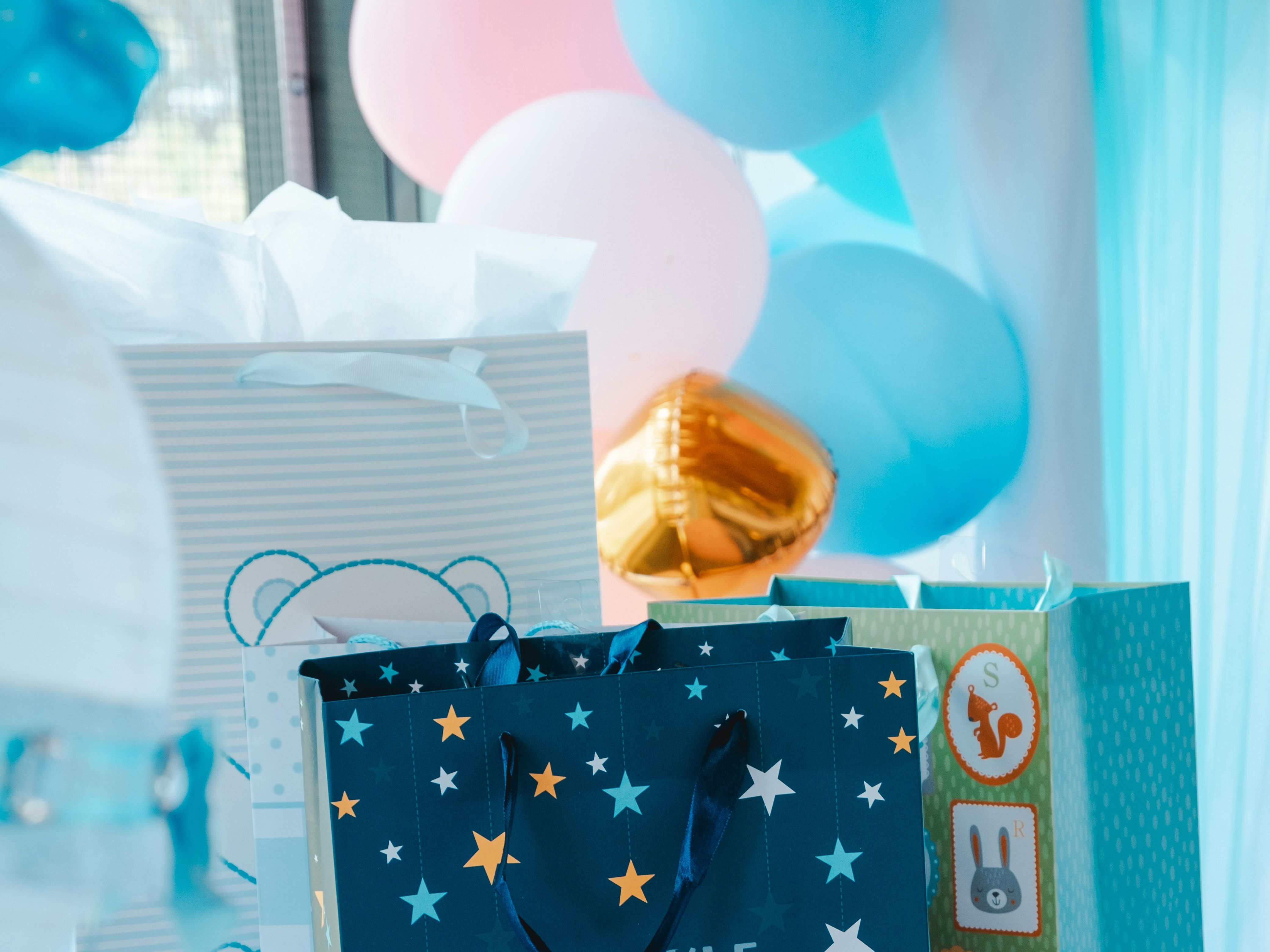 Twinkle Twinkle Little Star themed gift bag at a baby shower with blue cupcakes and balloons in the background
