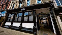 The exterior view of a pub called The Lion on Bridge Street, showing its entrance and signage.