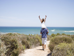 Father Carrying His Daughter To The Beach - Trenance Farm Cottages