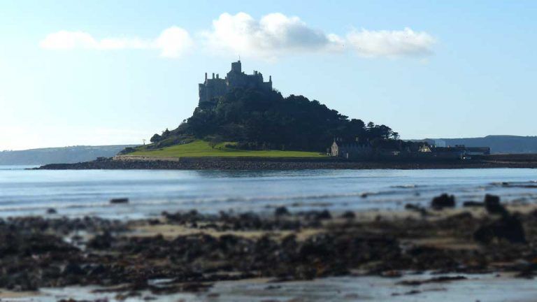 Island castle surrounded by the sea with a cloudy sky in Cornwall