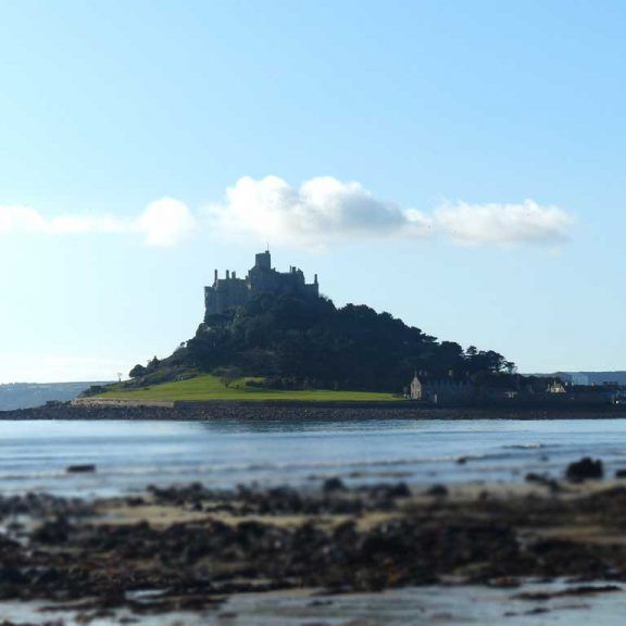 Island castle surrounded by the sea with a cloudy sky in Cornwall