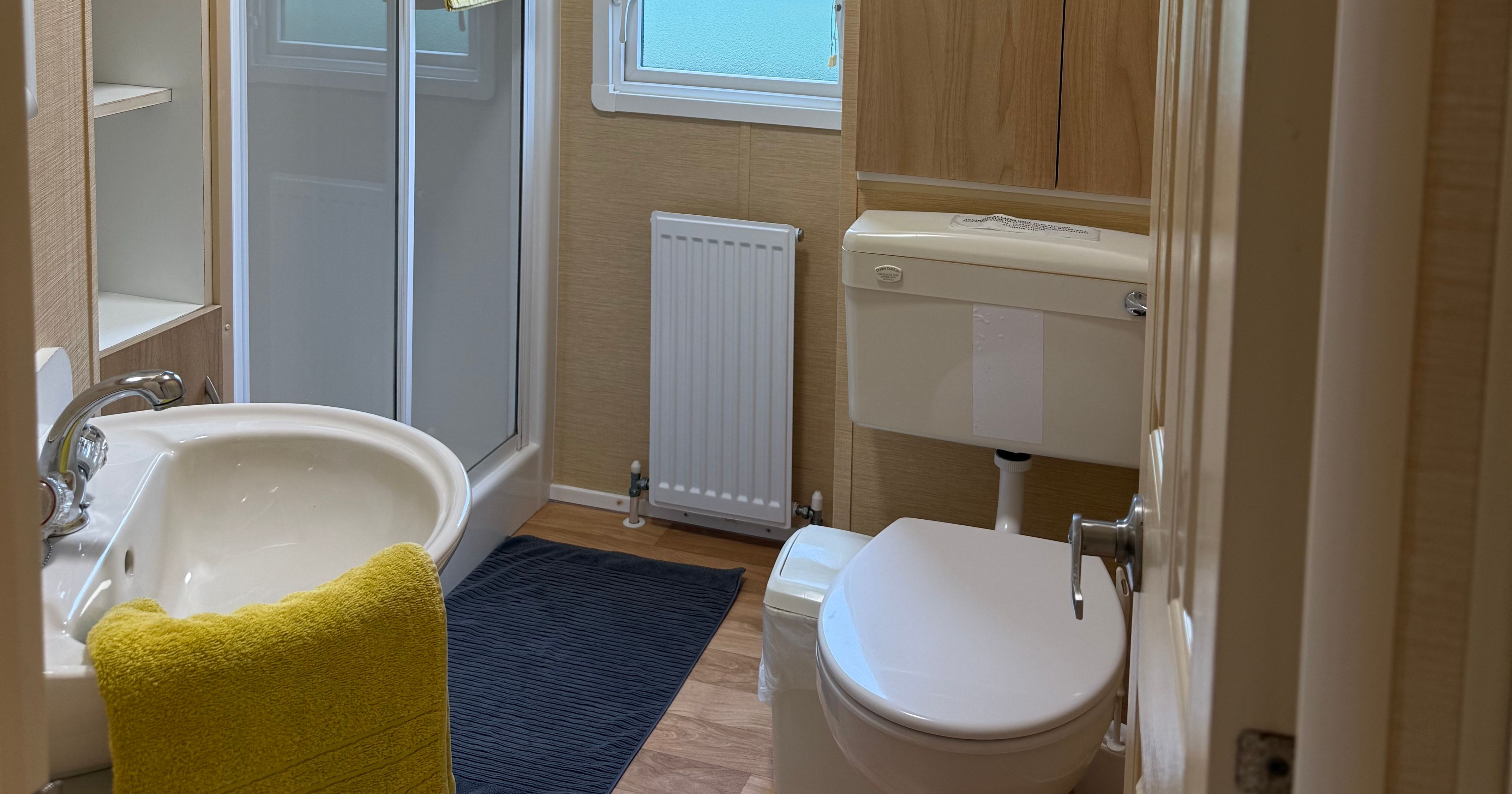 Small modern bathroom with shower, toilet, and sink