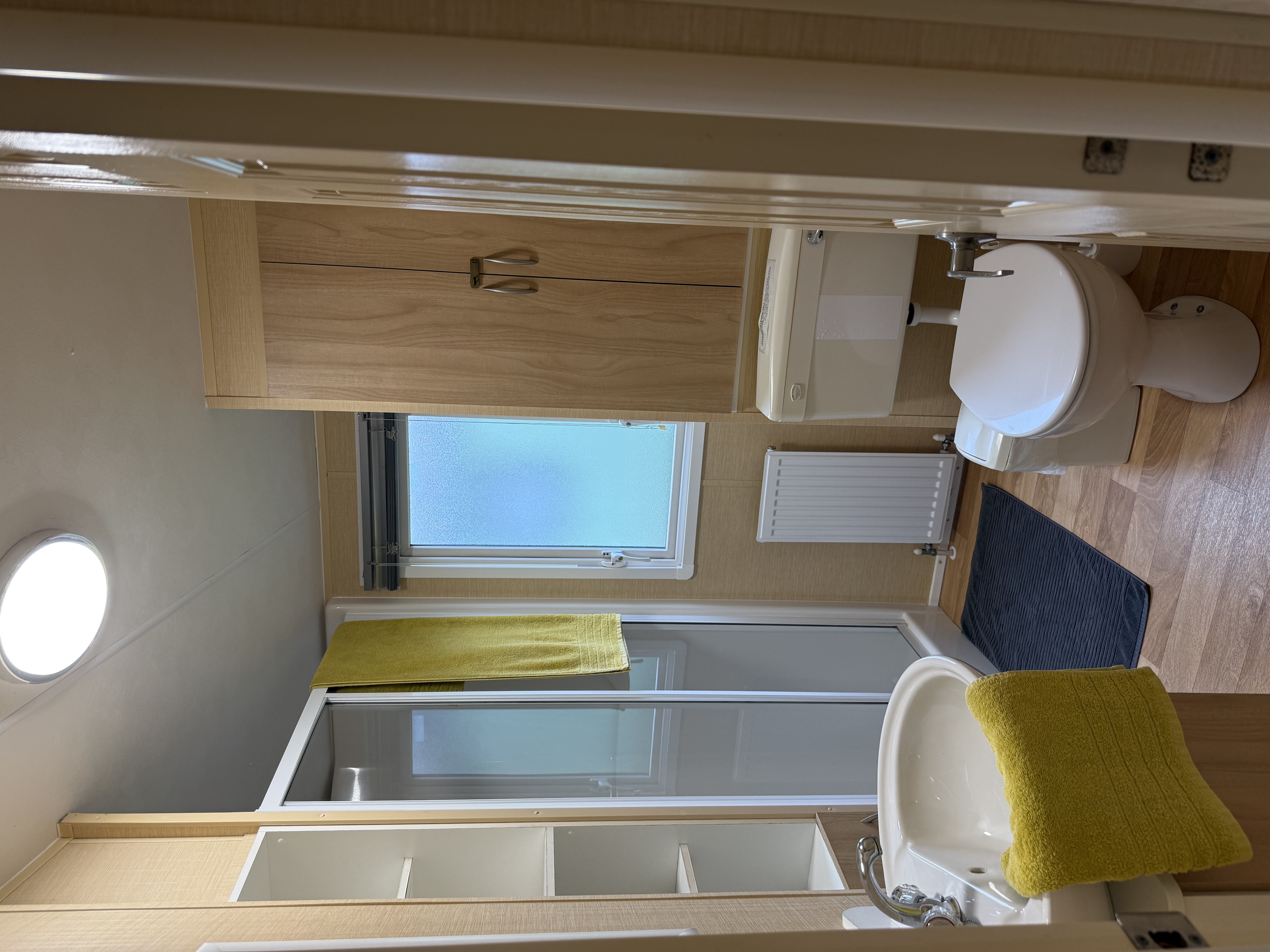 Small modern bathroom with shower, toilet, and sink