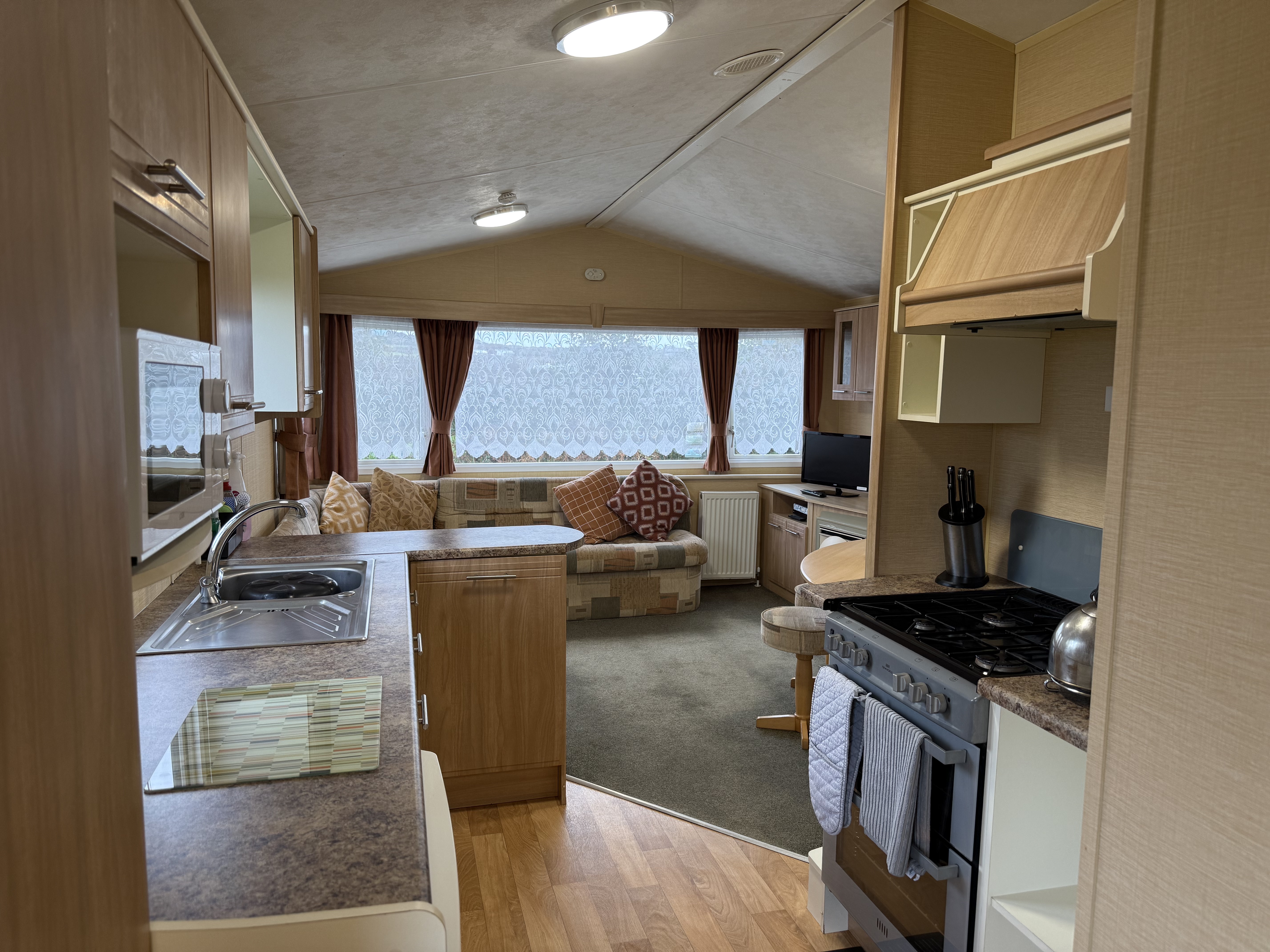 Interior of a cozy caravan with kitchen and living area.