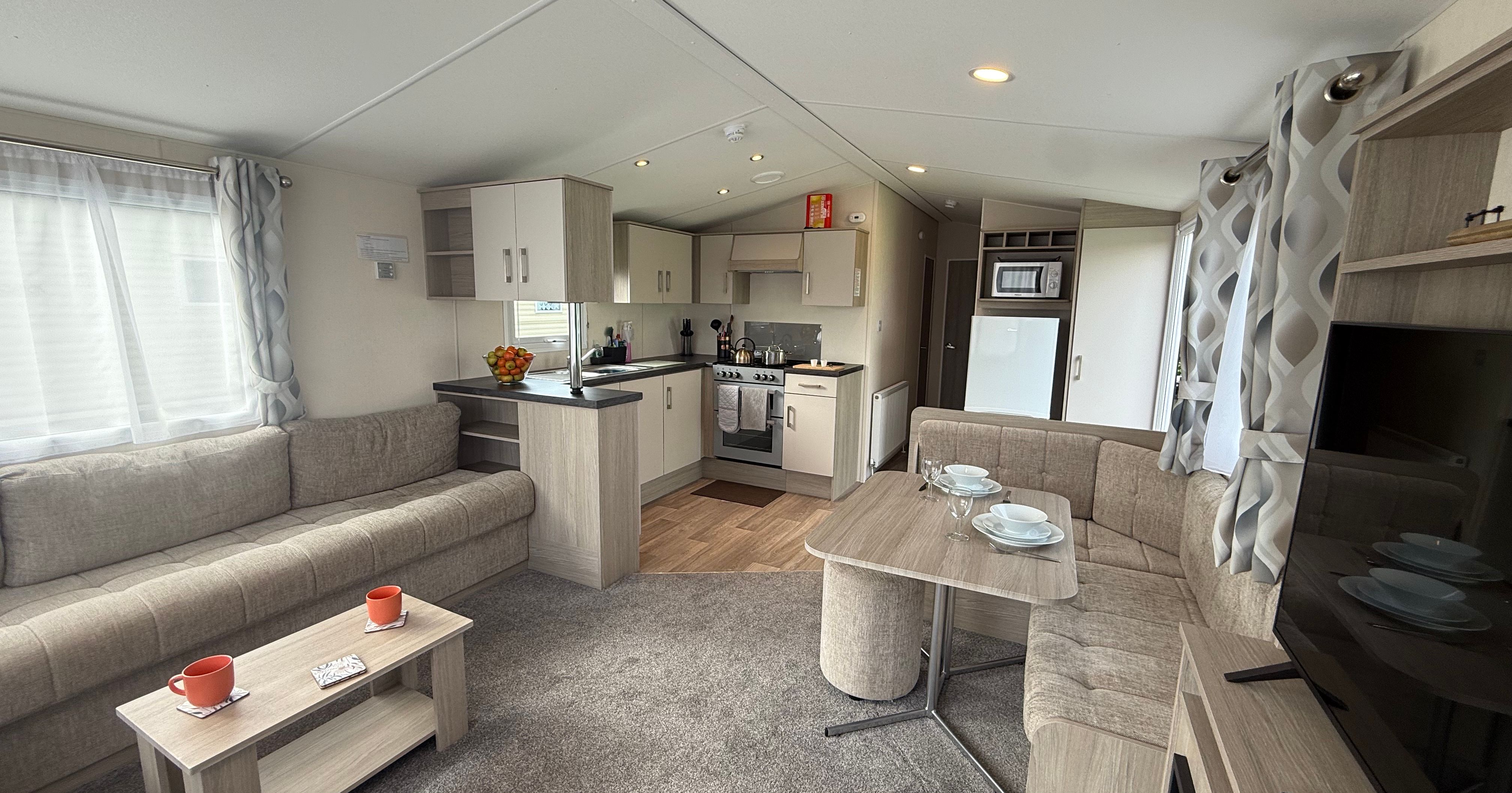 Modern caravan living area and kitchen interior.
