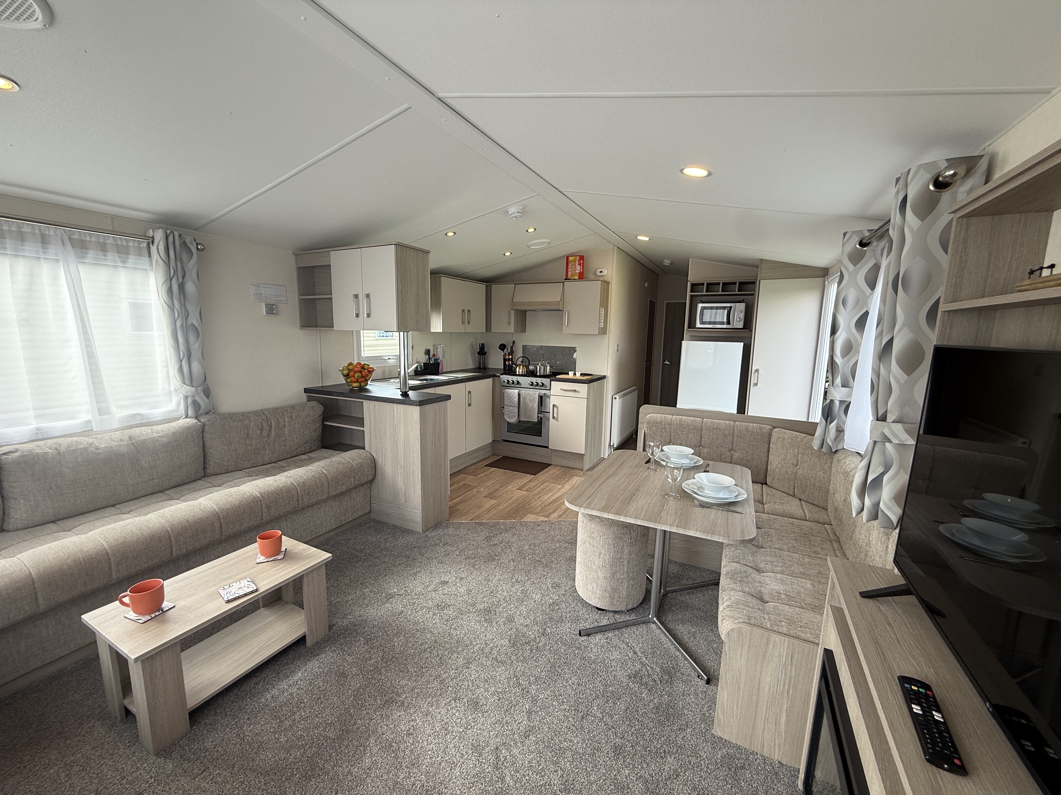 Modern caravan living area and kitchen interior.