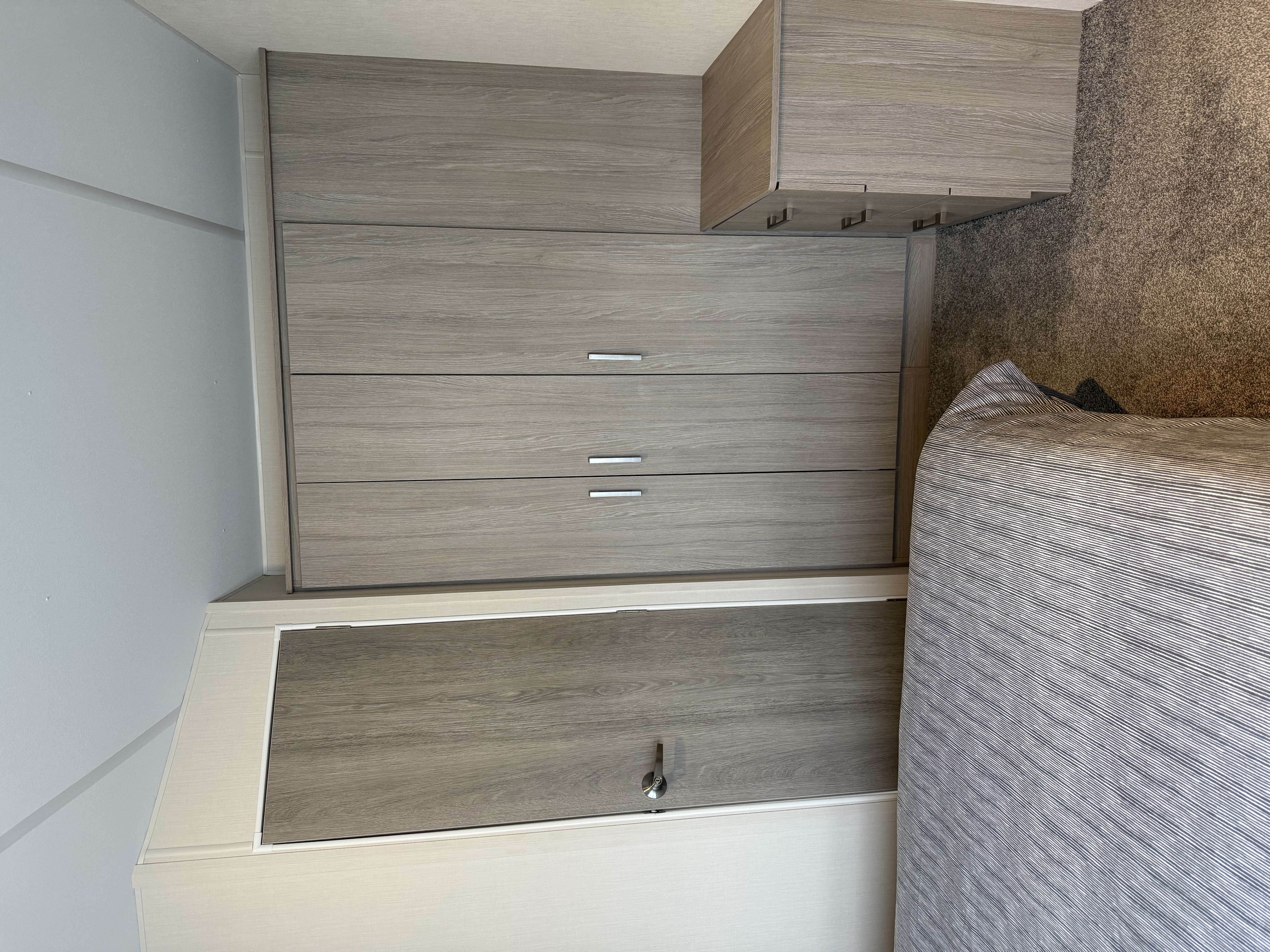 Modern bedroom with gray wardrobe and chest of drawers