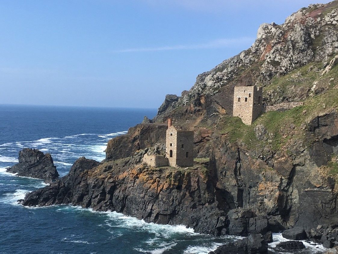 Historic stone buildings on rugged cliffside by the sea