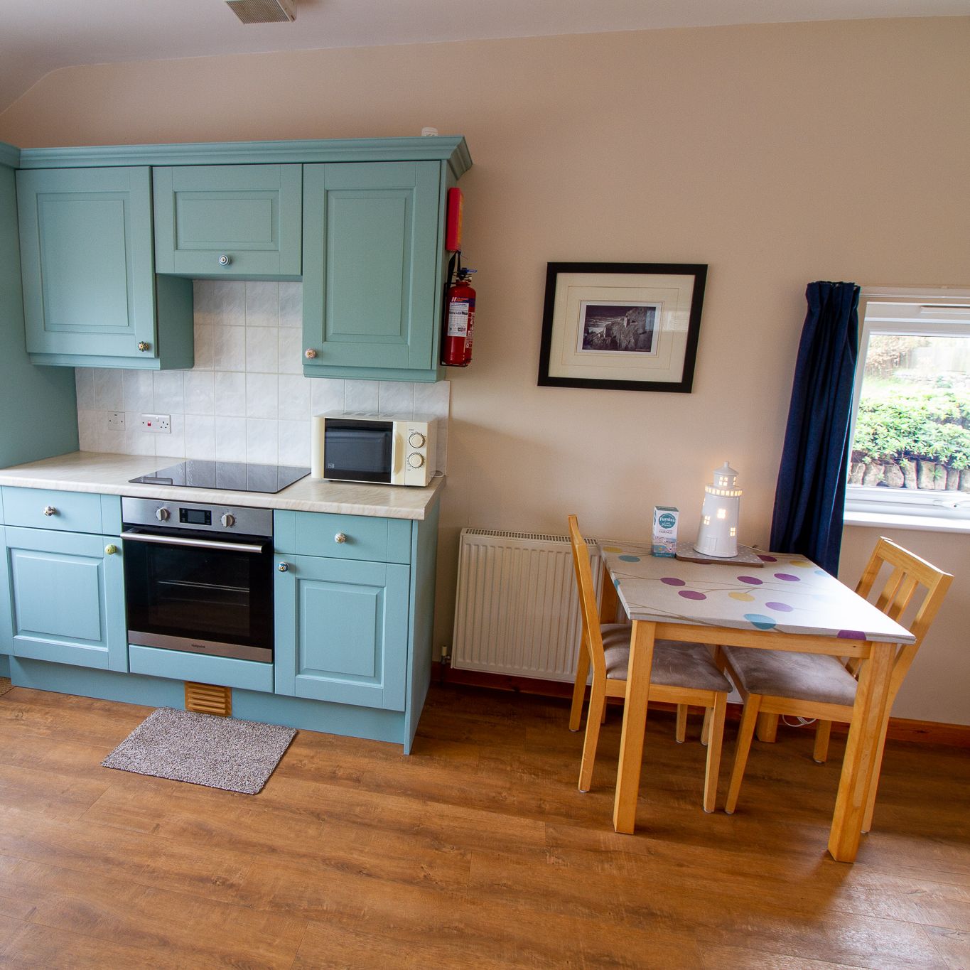 Cozy kitchen with blue cabinets and small dining table