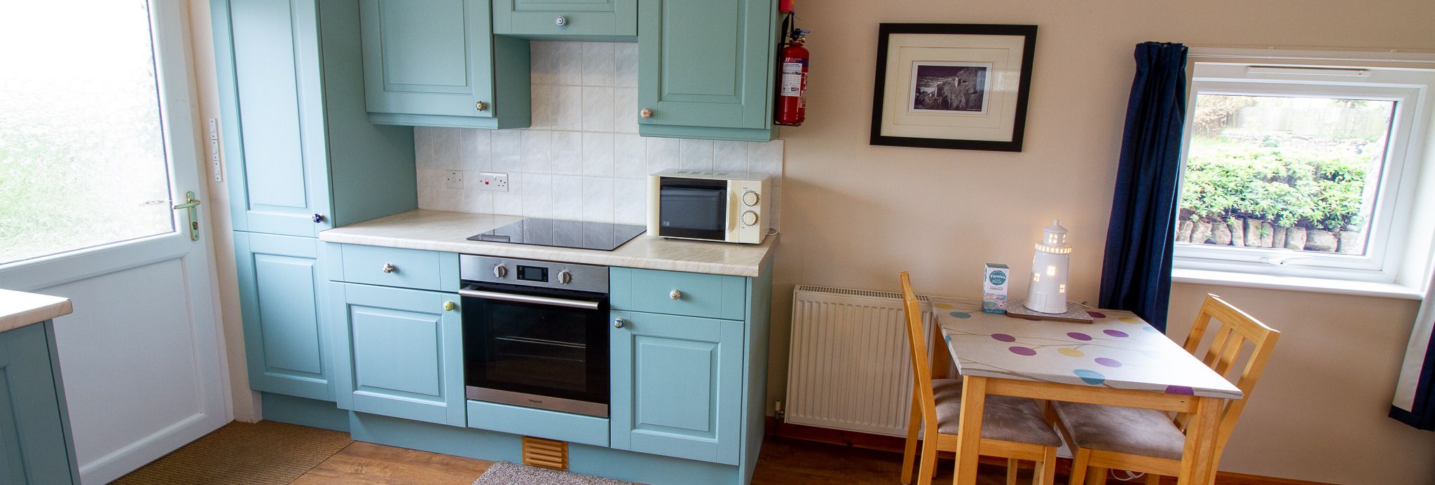 Cozy kitchen with blue cabinets and small dining table