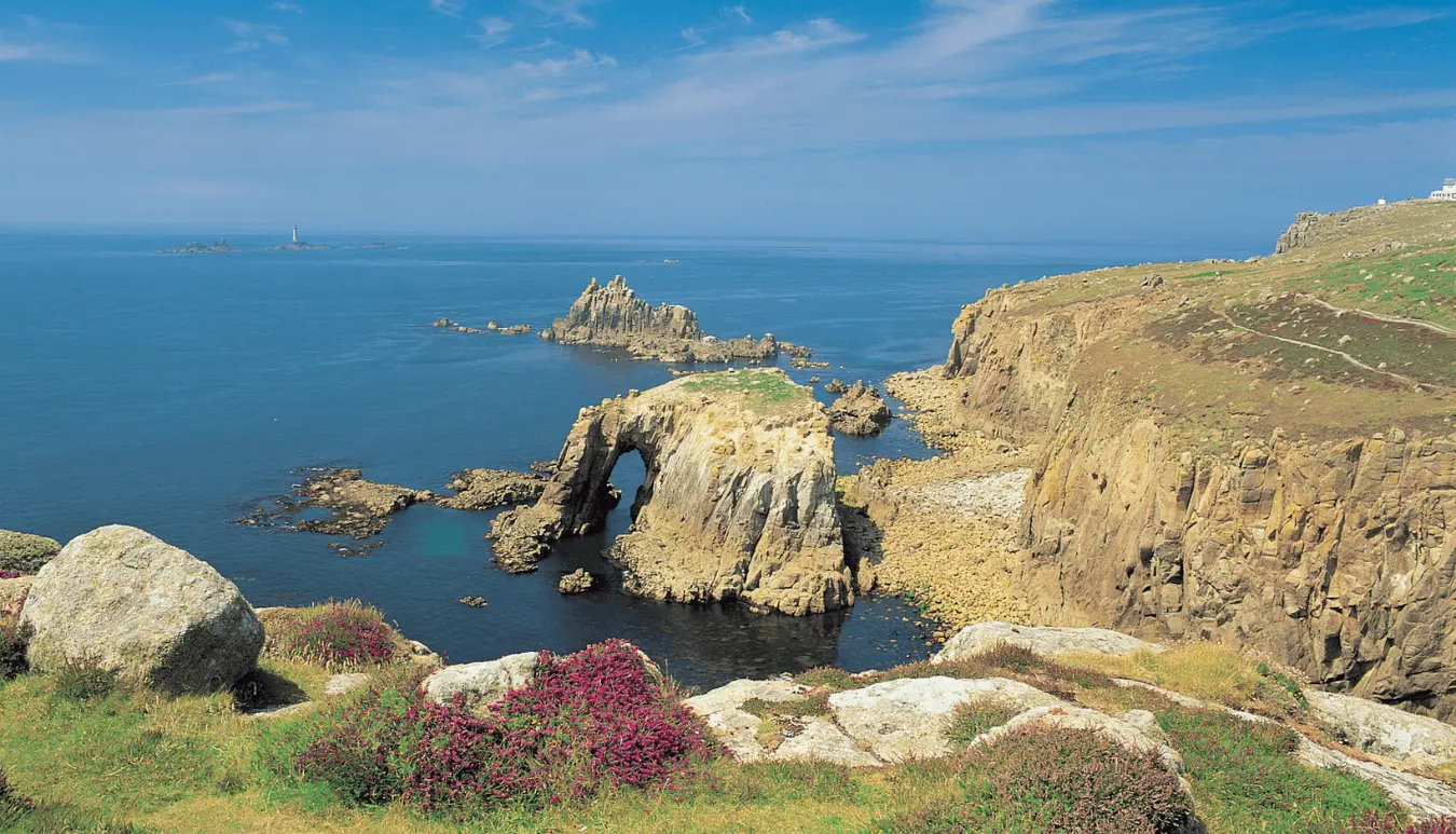 Rocky coastline with cliffs and blue sea under a clear sky