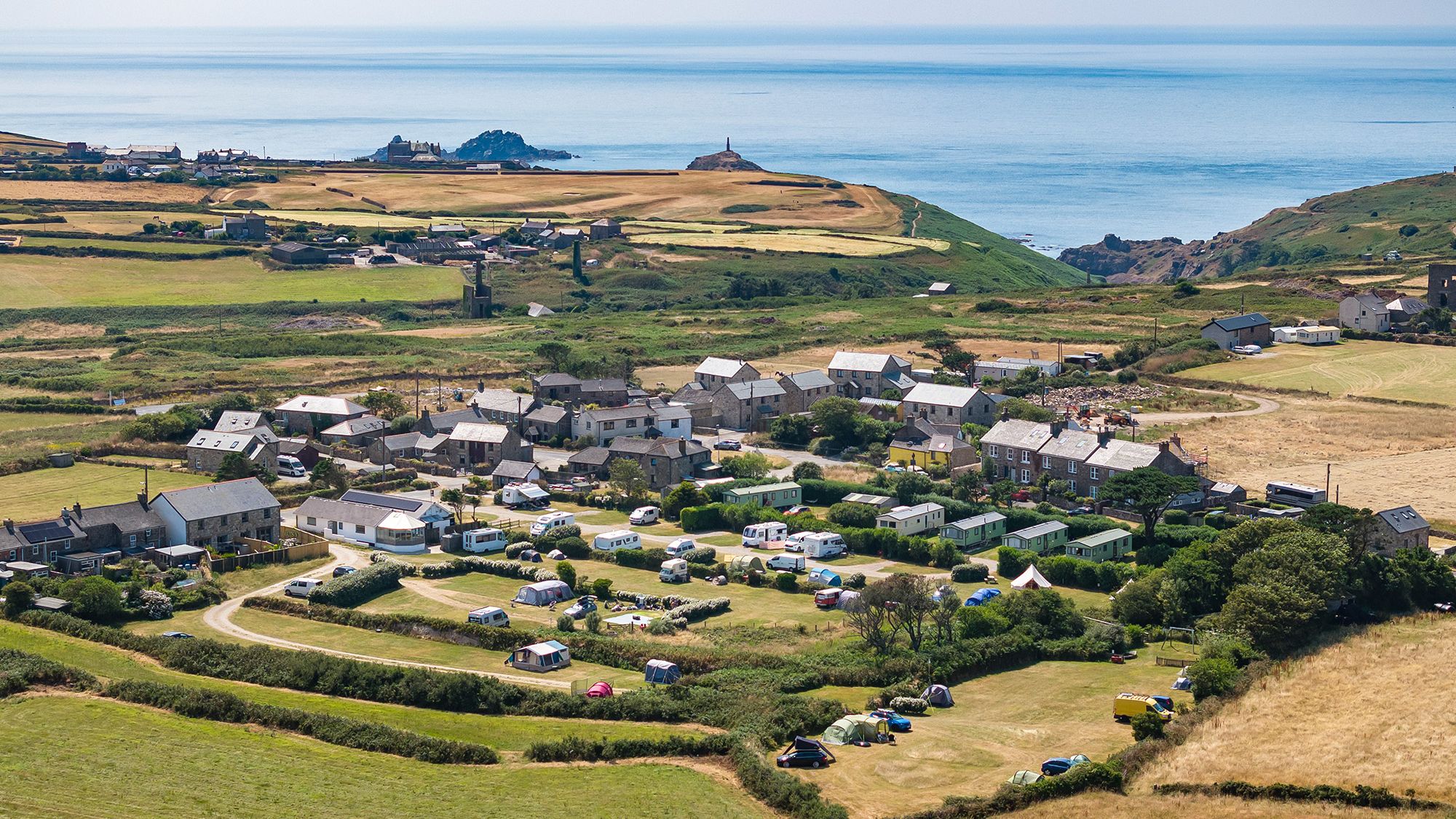Aerial view of Trevaylor Caravan and Camping Park with caravans and tents overlooking the Cornish coastline