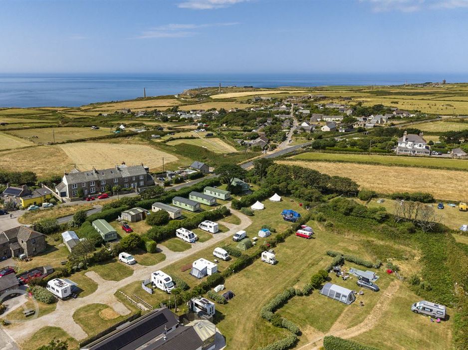 Aerial view of Trevaylor Caravan and Camping Park pitches with caravans, motorhomes and bell tents near the coast