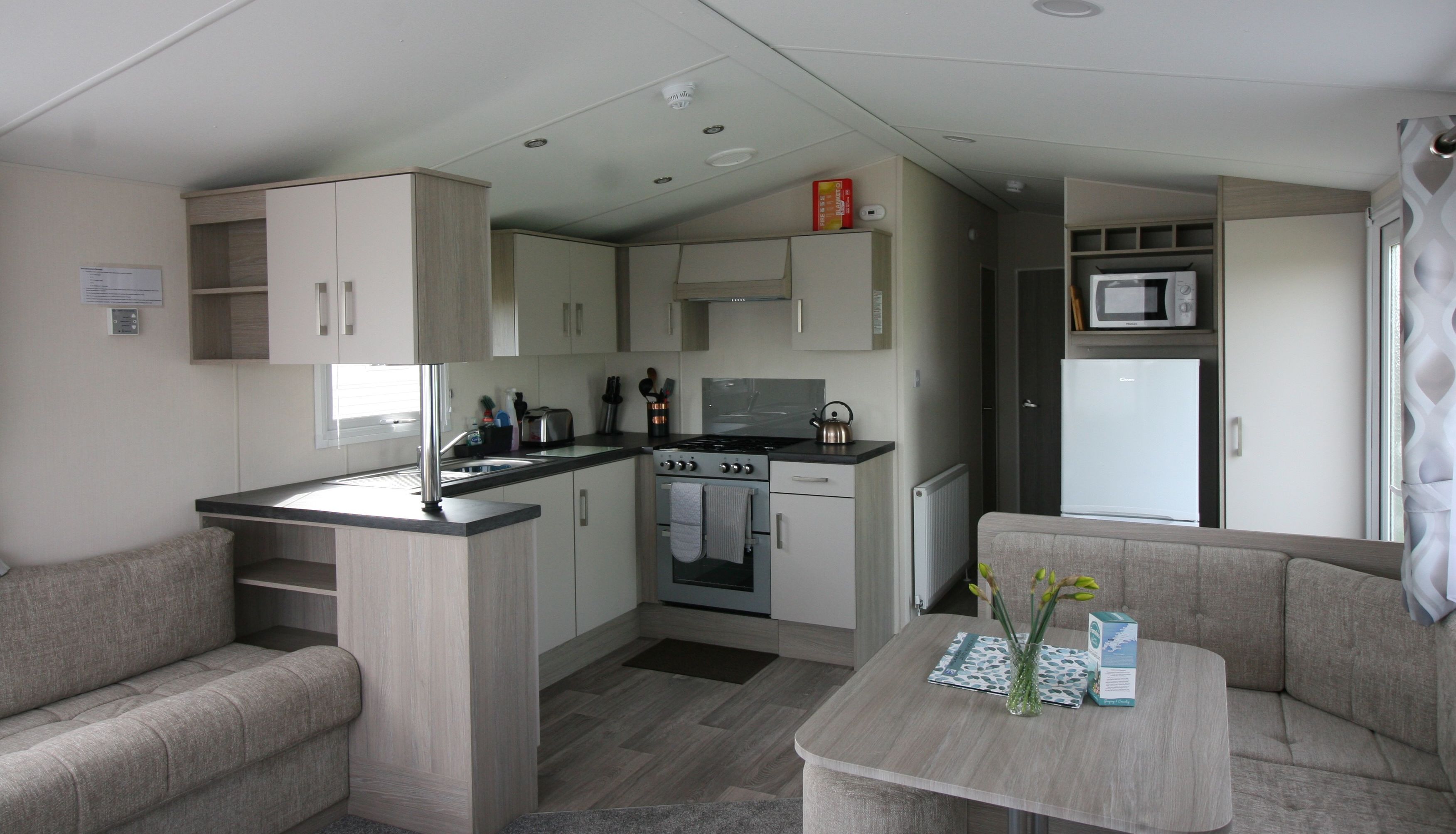 Modern compact kitchen and dining area in a small apartment or mobile home
