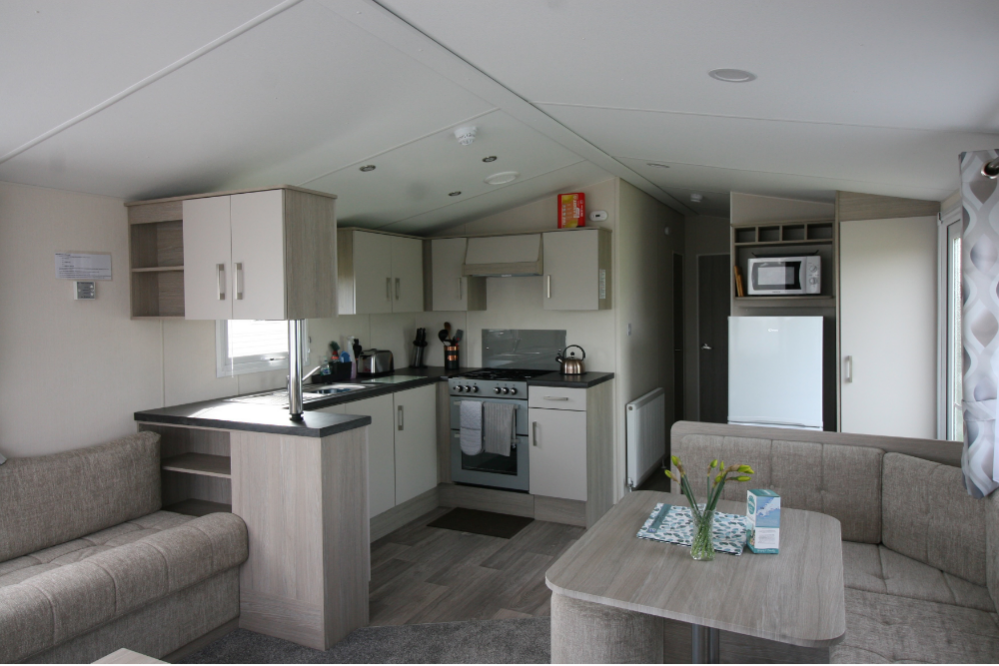 Modern compact kitchen and dining area in a small apartment or mobile home