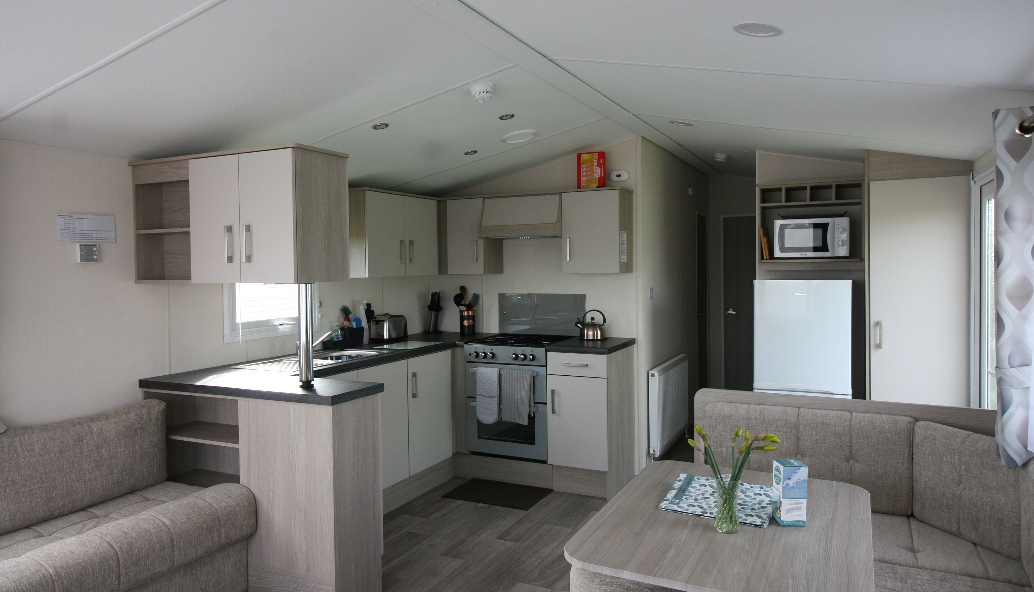 Modern compact kitchen and dining area in a small apartment or mobile home