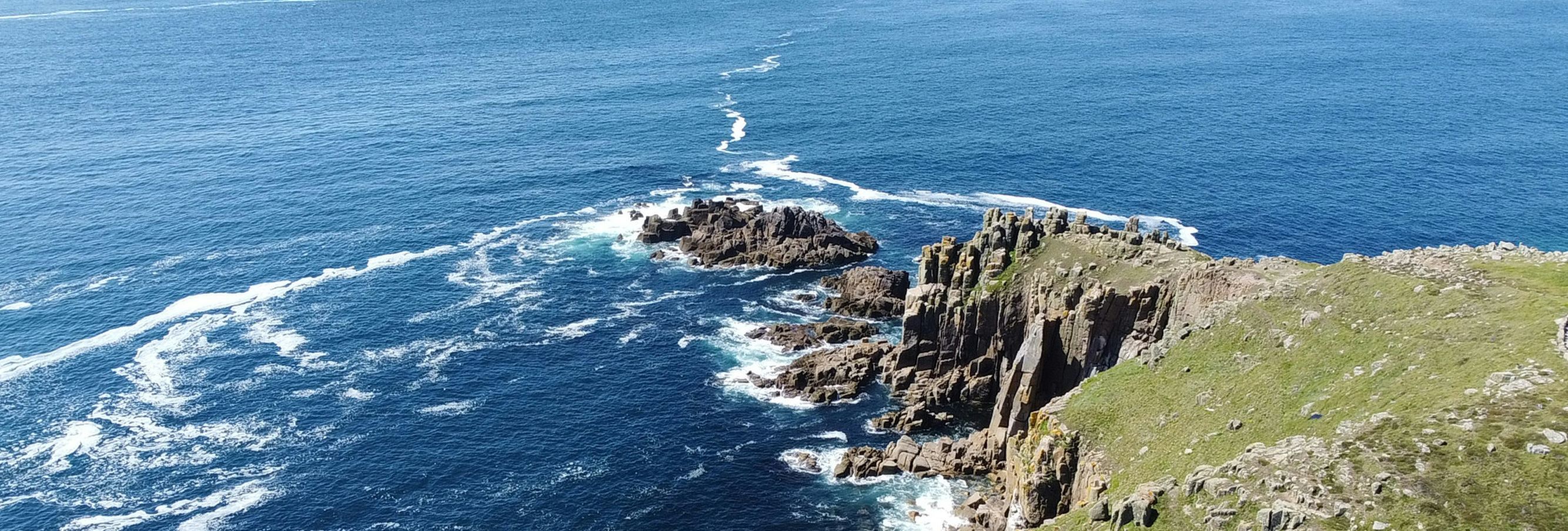 Rocky coastal cliffs overlooking the blue ocean