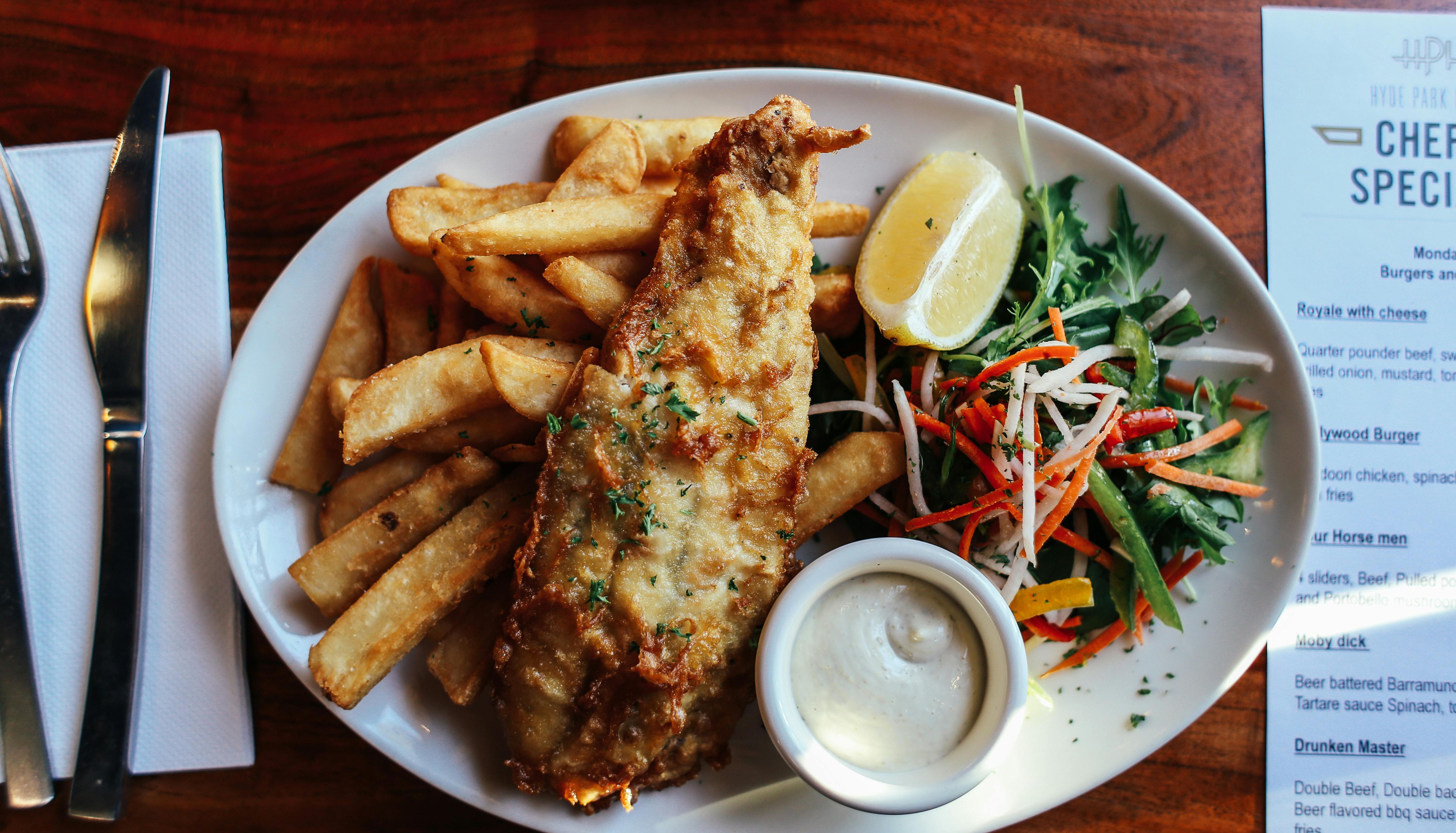 Plate of fish and chips with salad and tartar sauce