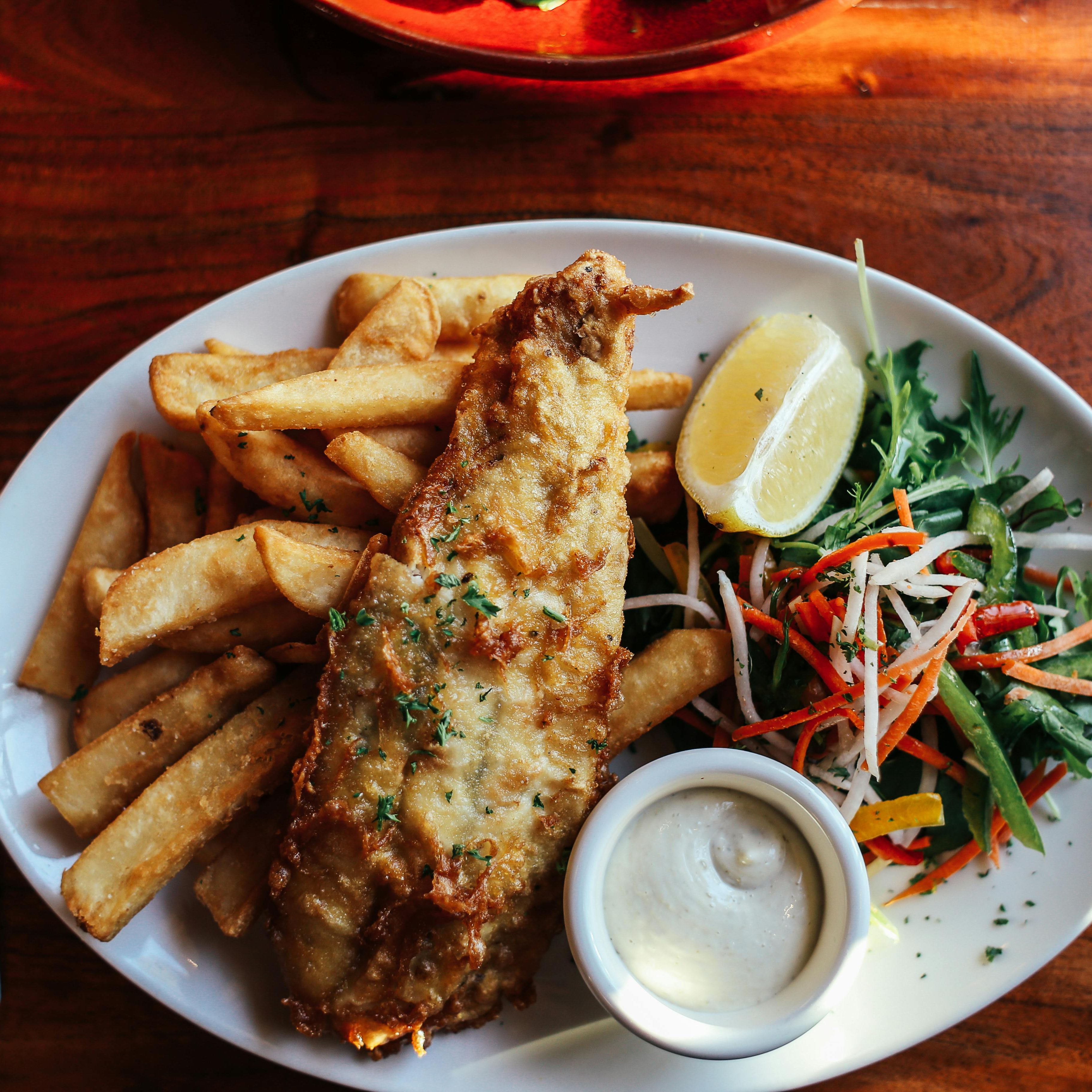 Plate of fish and chips with salad and tartar sauce