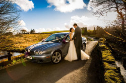 Maggie McCall - bride and groom by car