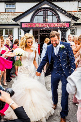 Maggie McCall - bride and groom confetti outside