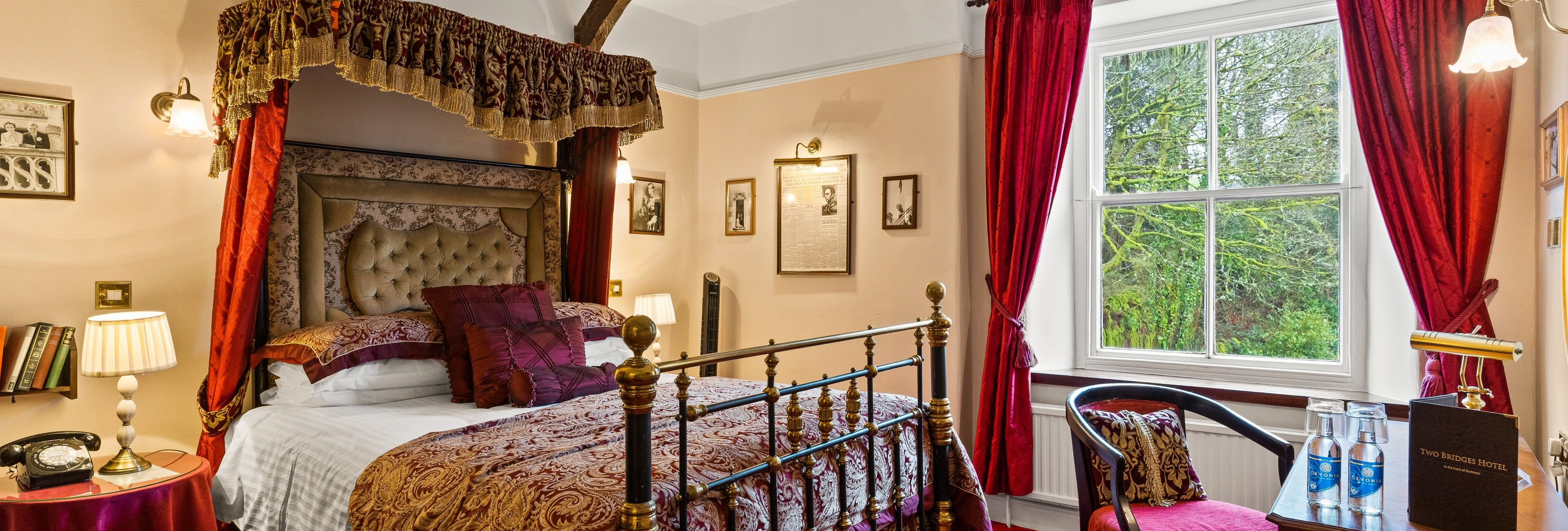 Classic hotel room with ornate bed, vintage decor, and red accents