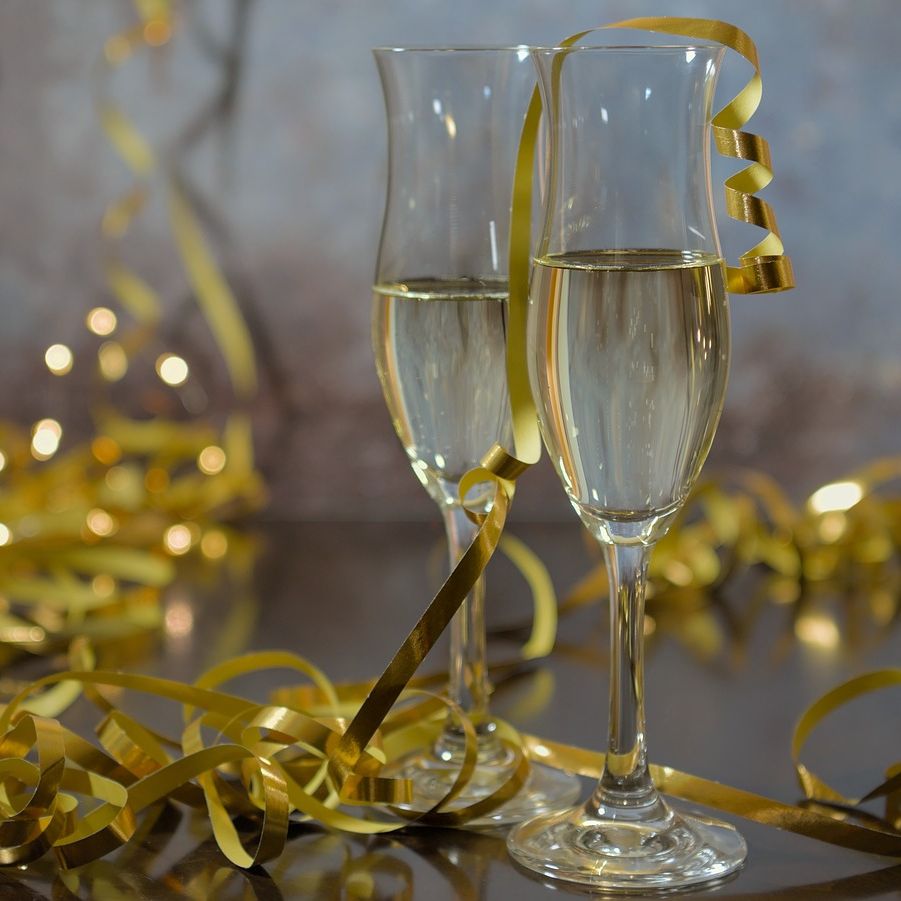 Two champagne glasses with golden ribbon decorations