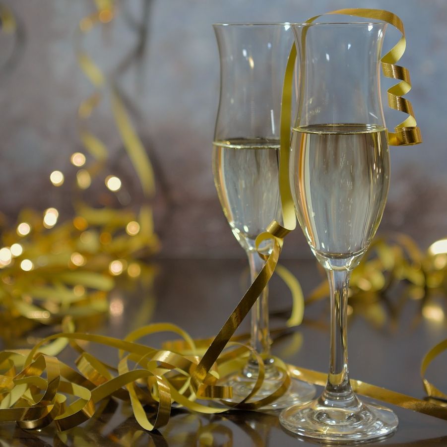 Two champagne glasses with golden ribbon decorations