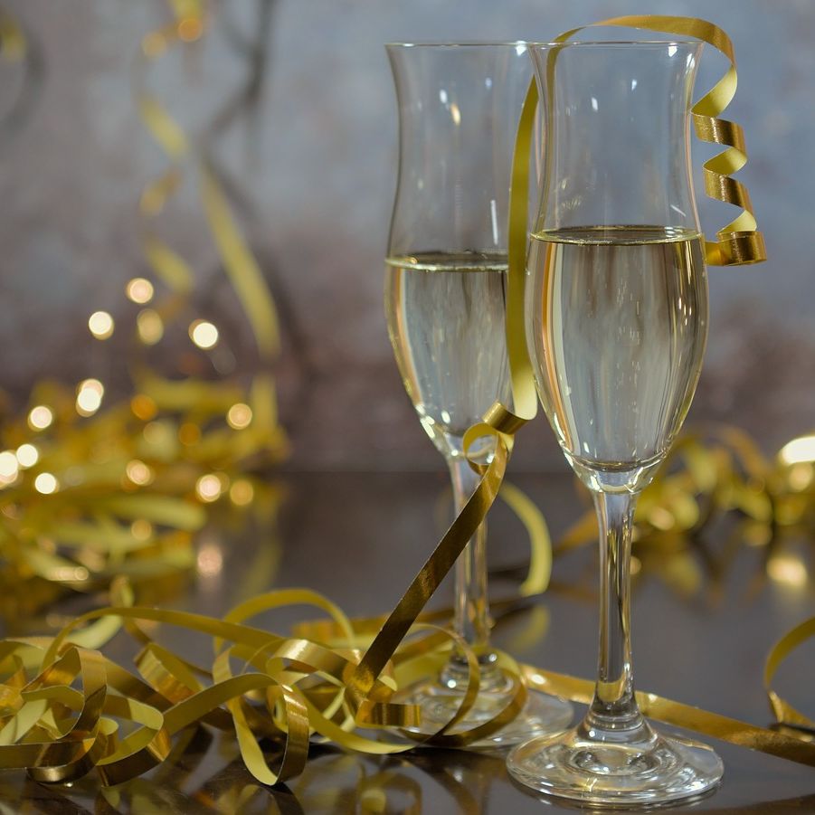 Two champagne glasses with golden ribbon decorations