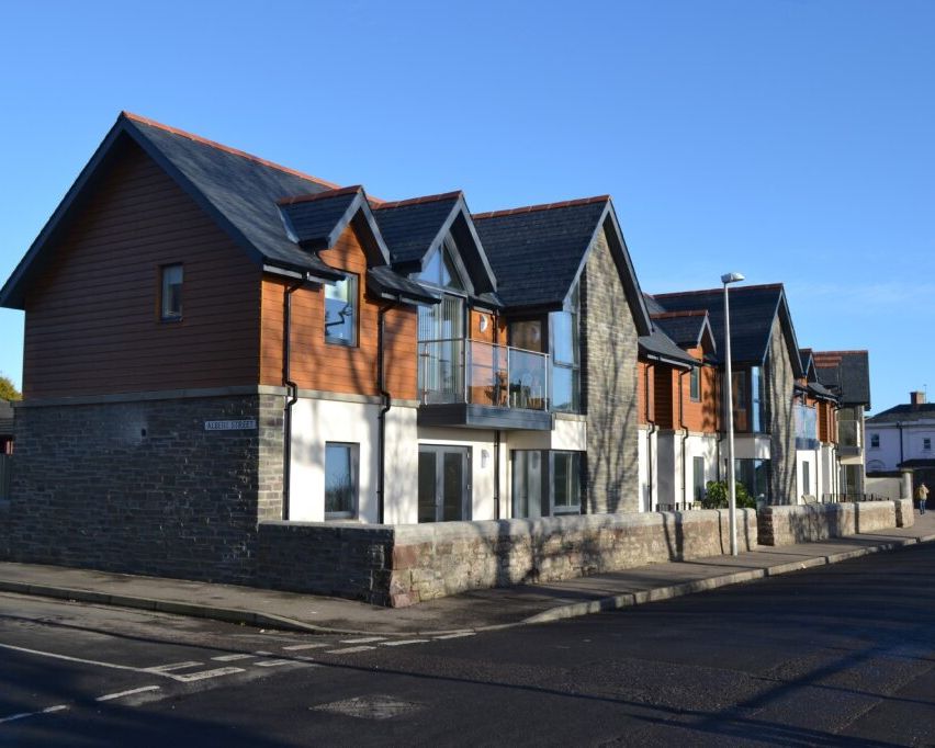 Modern row of townhouses with stone and wood exterior