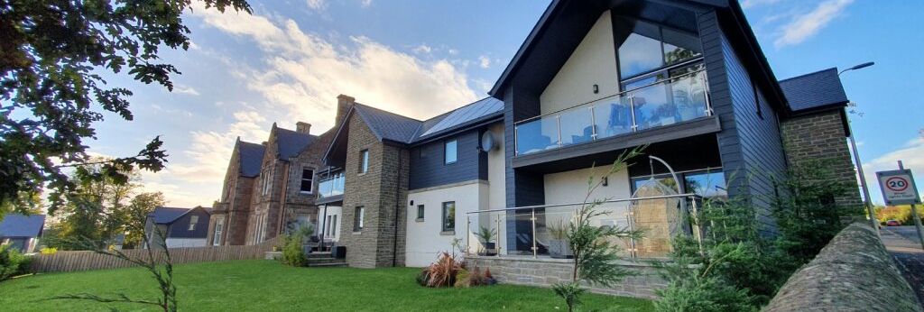 Modern house with large windows and stone accents on a sunny day
