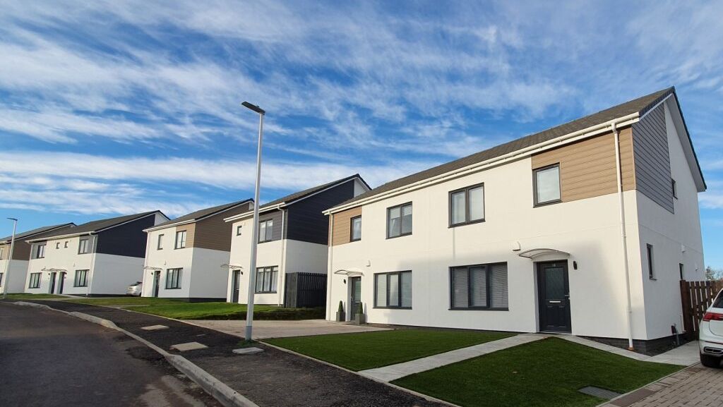 Row of modern suburban houses under a blue sky