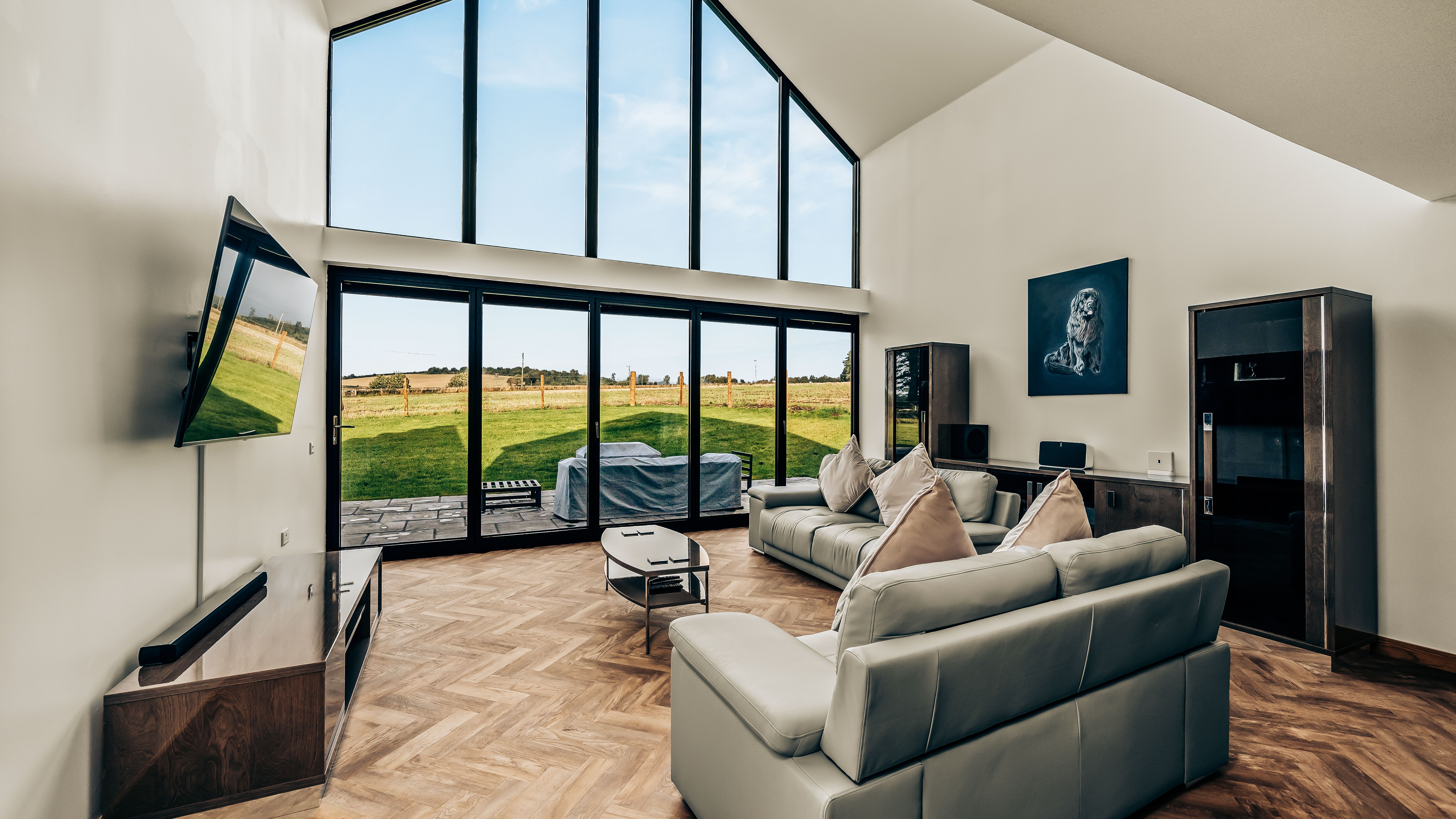 Modern living room with large floor-to-ceiling windows and a scenic outdoor view
