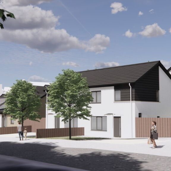 Modern residential street with white houses, trees, and people walking