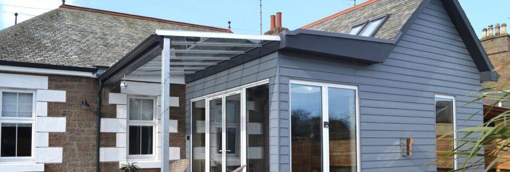 Modern house extension with large glass doors and patio