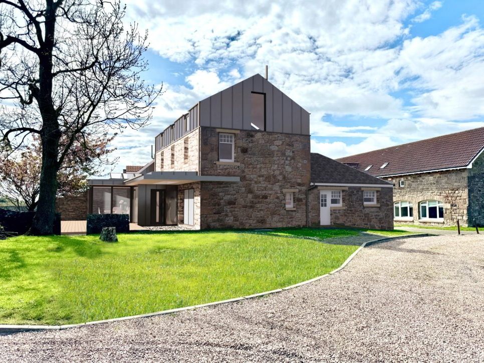 Modern stone house with metal roof extension, surrounded by green lawn and gravel driveway